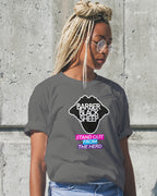 Person wearing a gray t-shirt with a graphic design and text against a concrete wall.